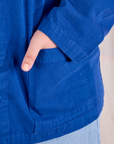 Ripstop Work Jacket in Royal Blue front pocket close up. Juliet has her hand in the pocket.