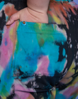 Close up of Ashley's hand in the back pocket of Short Sleeve Jumpsuit in Rainbow Magic Waters