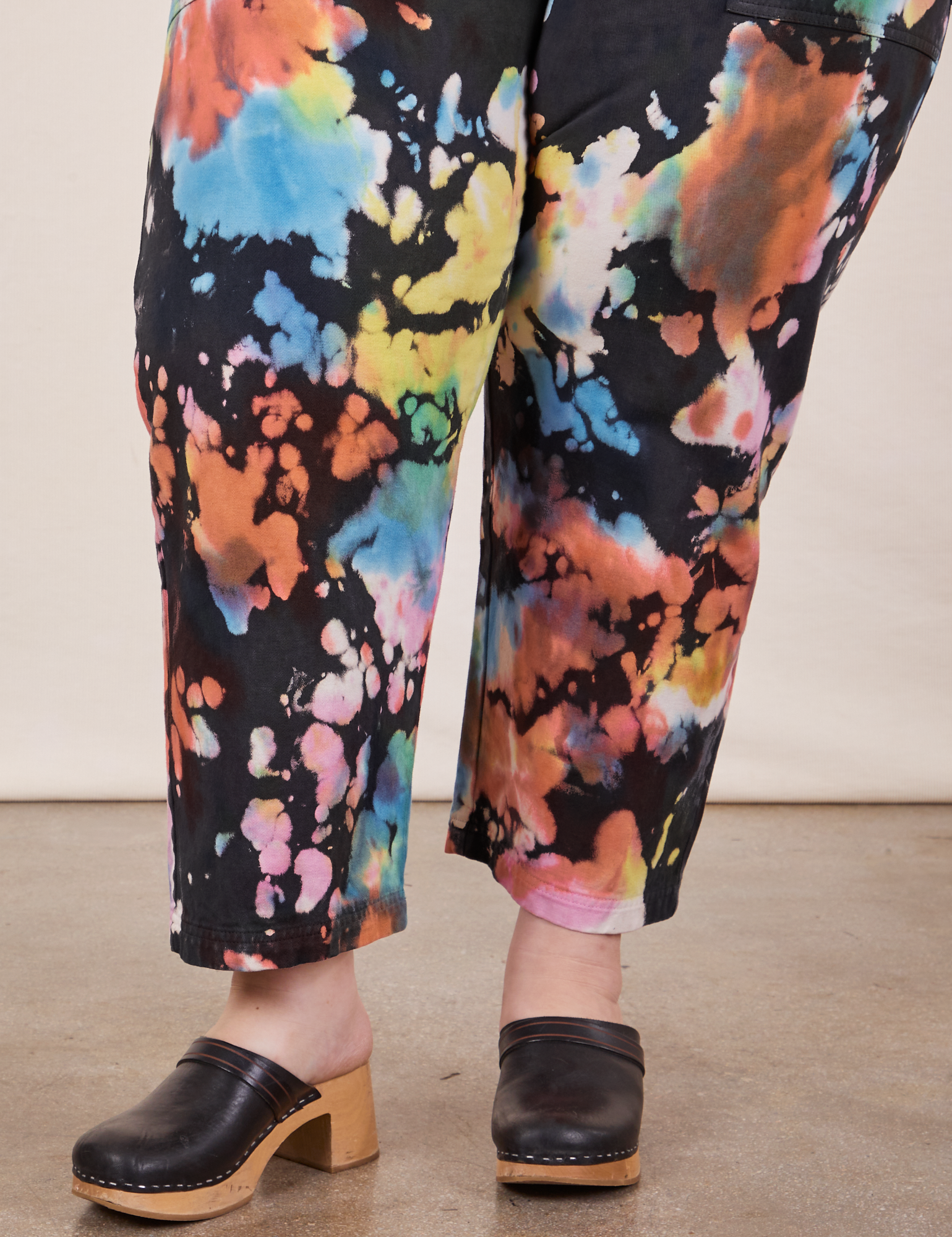 Pant leg close up of Petite Short Sleeve Jumpsuit in Rainbow Magic Waters worn by Ashley