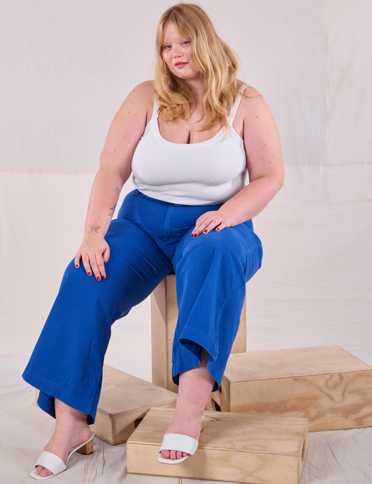 Juliet is wearing Bell Bottoms in Royal Blue and Cami in Vintage Tee Off-White