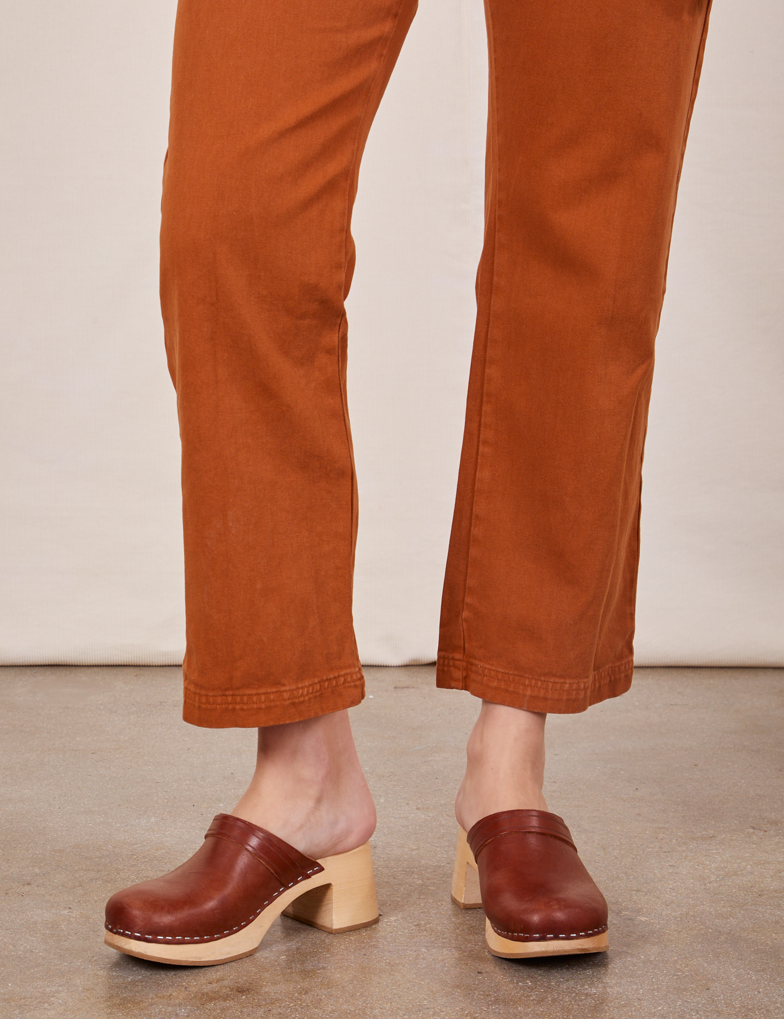 Pant leg close up of Short Sleeve Jumpsuit in Burnt Terracotta worn by Alex