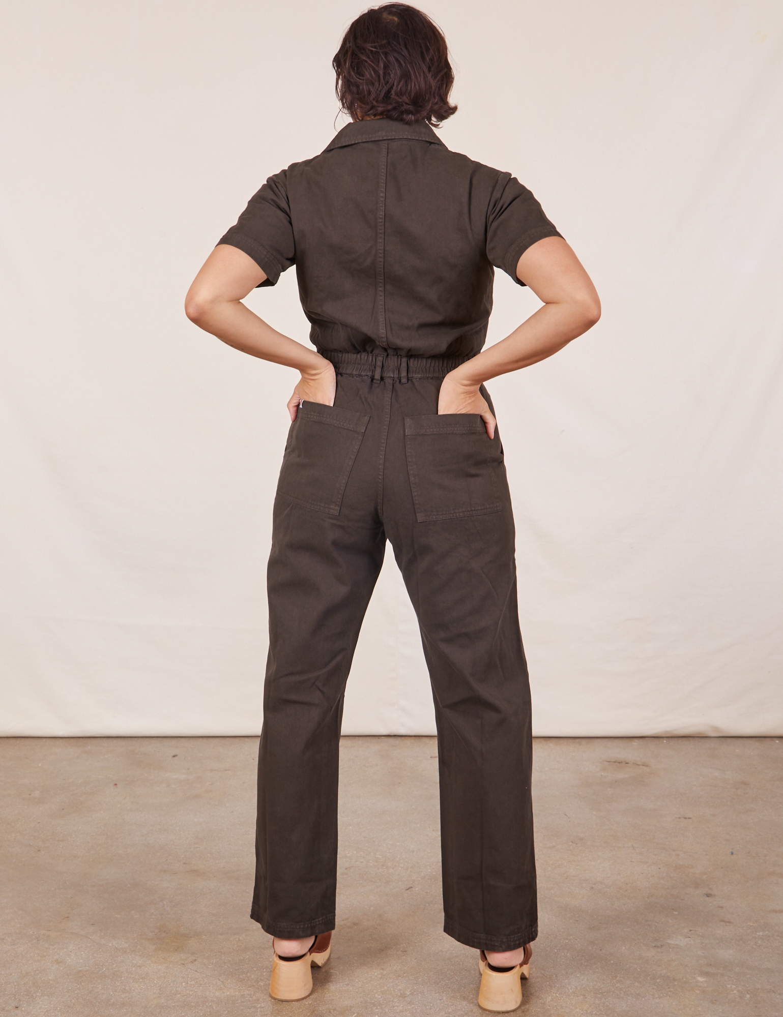 Back view of Short Sleeve Jumpsuit in Espresso Brown worn by Tiara.