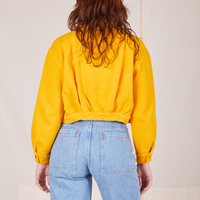 Back view of Ricky Jacket in Sunshine Yellow worn by Alex