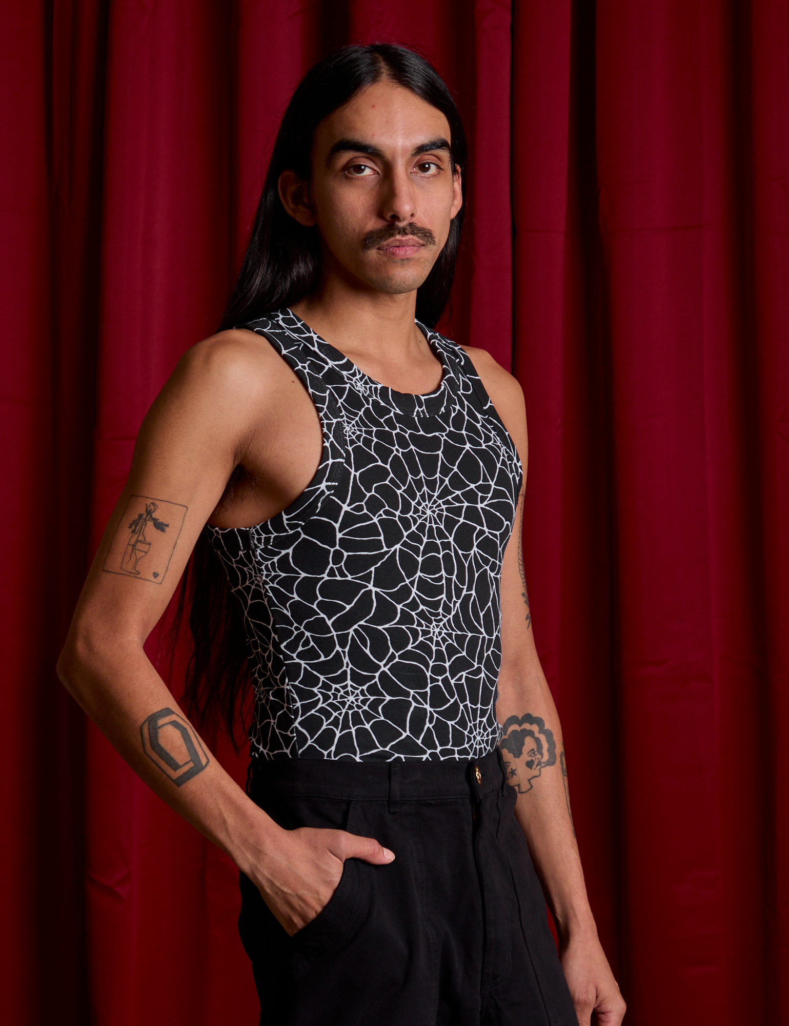 Angled front view of Spider Webs Racerback Tank on Anthony