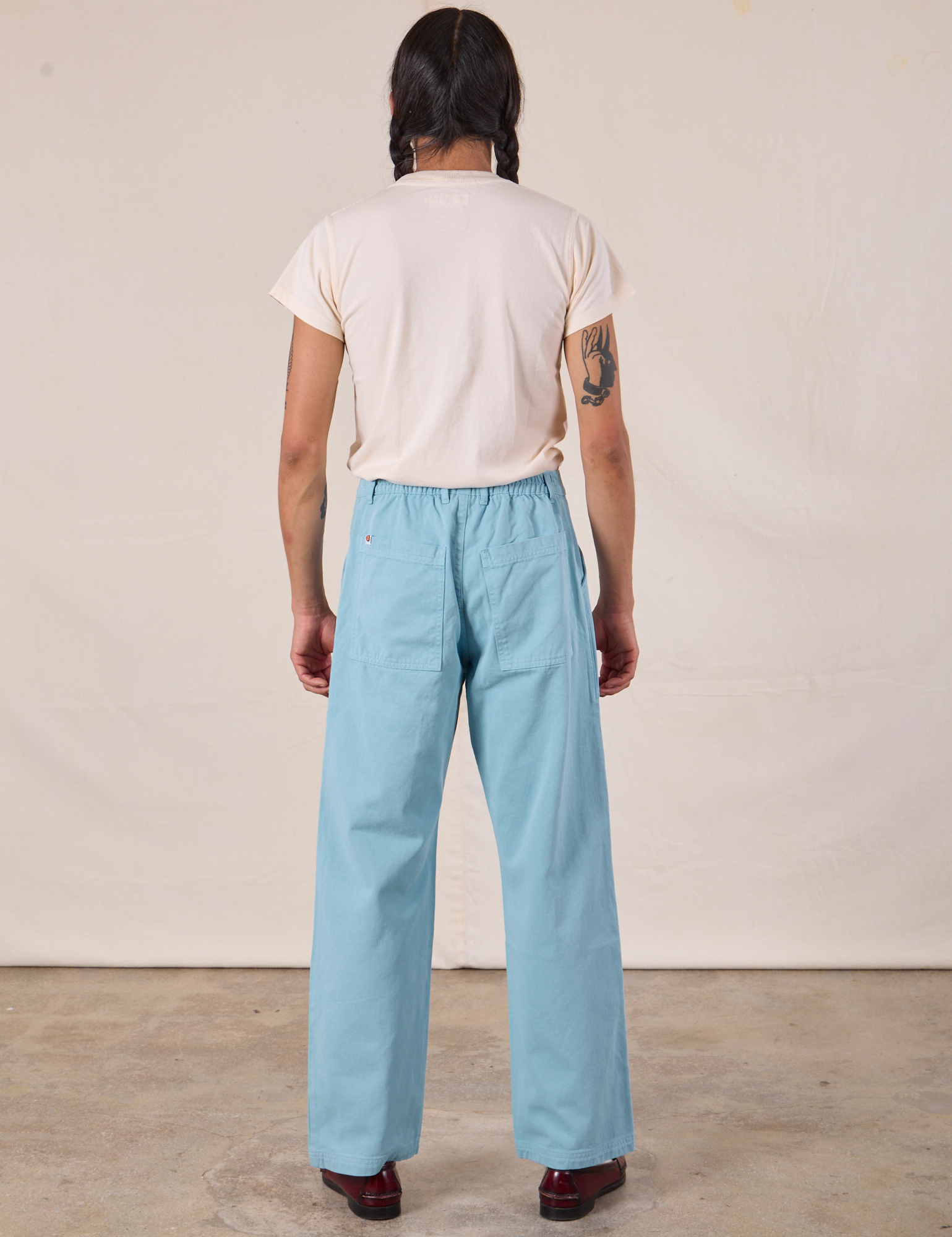 Back view of Work Pants in Baby Blue and Organic Vintage Tee in Vintage Tee Off-White on Anthony