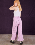 Angled back view of Star Bell Bottoms in Lilac Purple and Cropped Tank in vintage tee off-white on Margaret