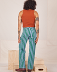 Back view of Stripe Work Pants in Green and burnt terracotta Cropped Tank worn by Jesse