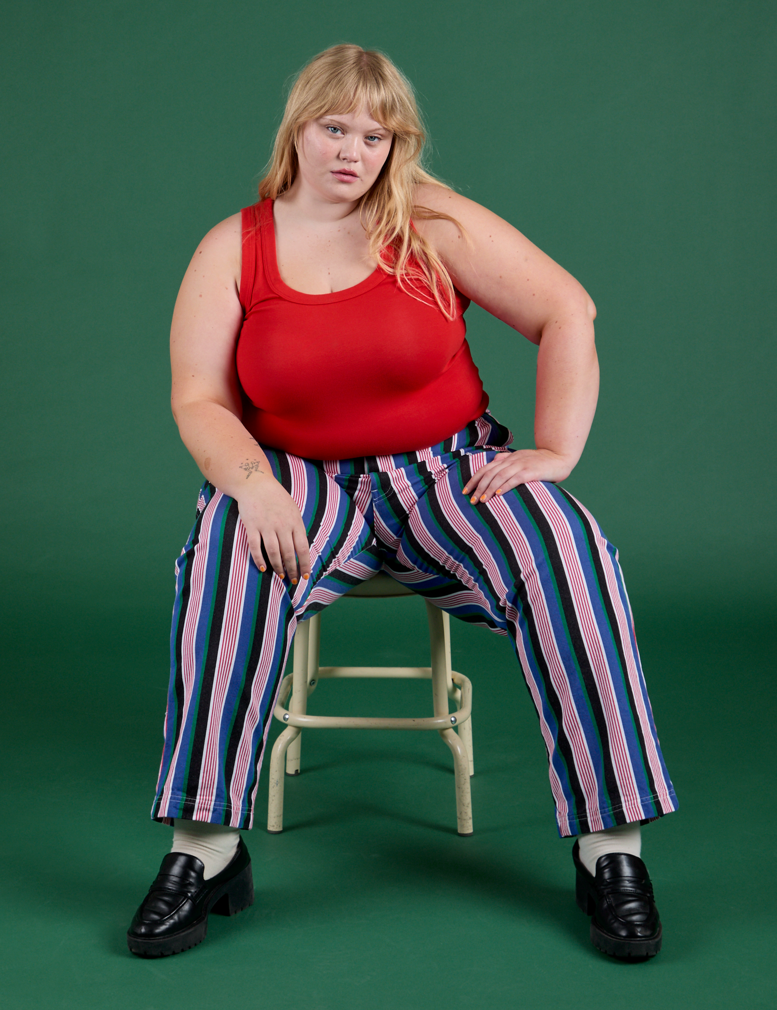Juliet is wearing Work Pants in Pacific Stripe paired with mustang red Cropped Tank