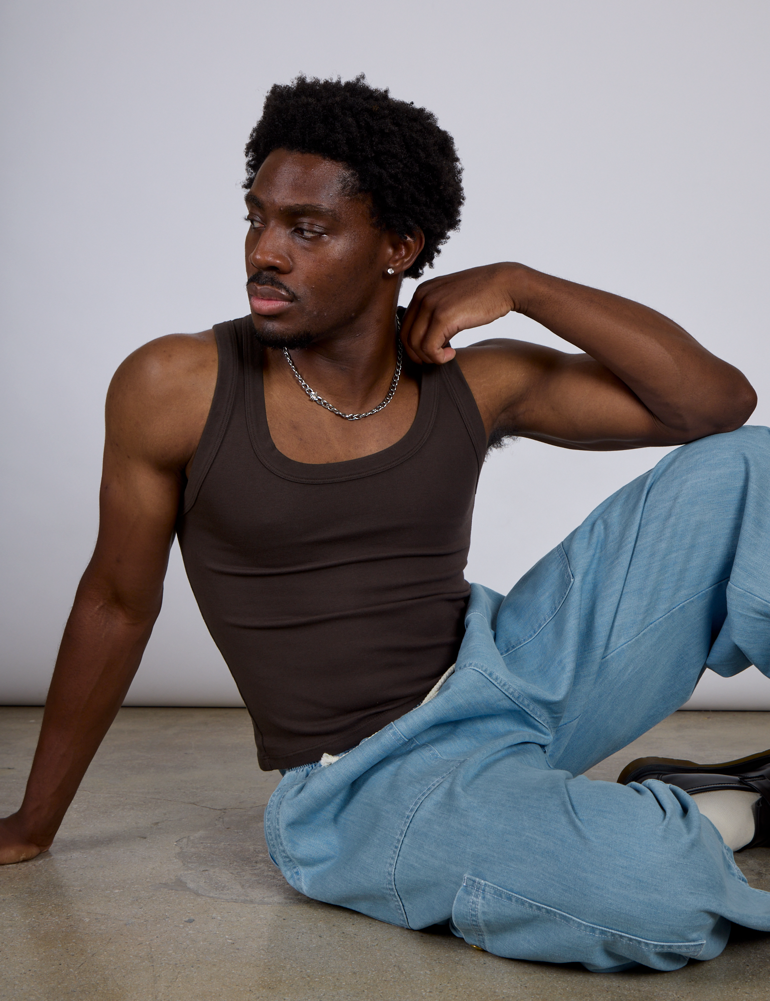 Isaac is wearing The Tank Top in Espresso Brown