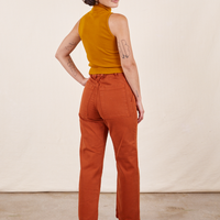 Work Pants in Burnt Terracotta back view on Soraya wearing spicy mustard Sleeveless Essential Turtleneck