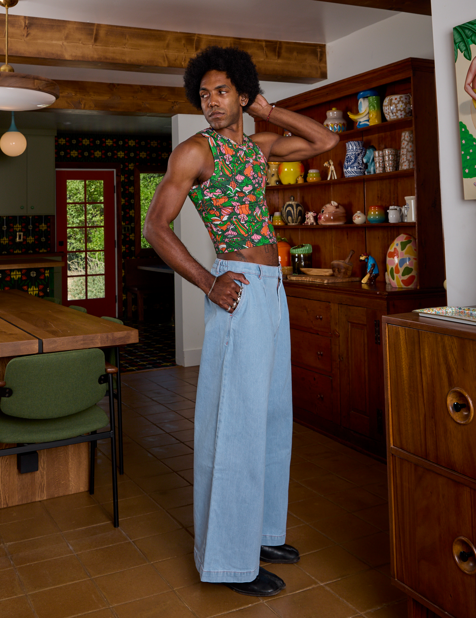 Side view of Kitchen Collection Racerback Tank and light wash Indigo Wide Leg Trousers on Jerrod