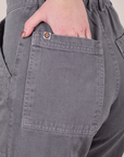 Close up of Hana's hand in the back pocket of Work Pants in Washed Grey