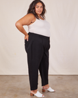 Side view of Western Pants in Basic Black and vintage off-white Tank Top worn by Alicia