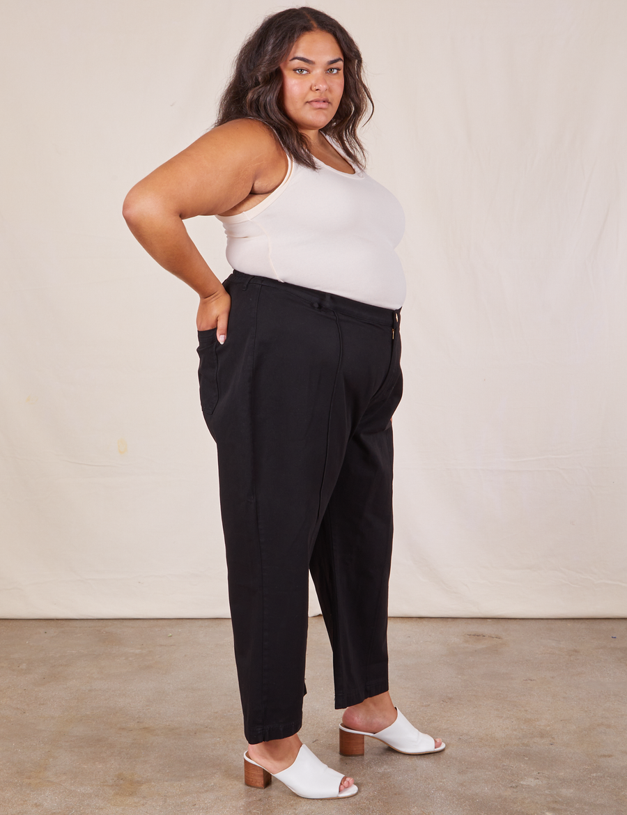 Side view of Western Pants in Basic Black and vintage off-white Tank Top worn by Alicia