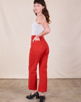 Angled back view of Western Pants in Mustang Red on Alex