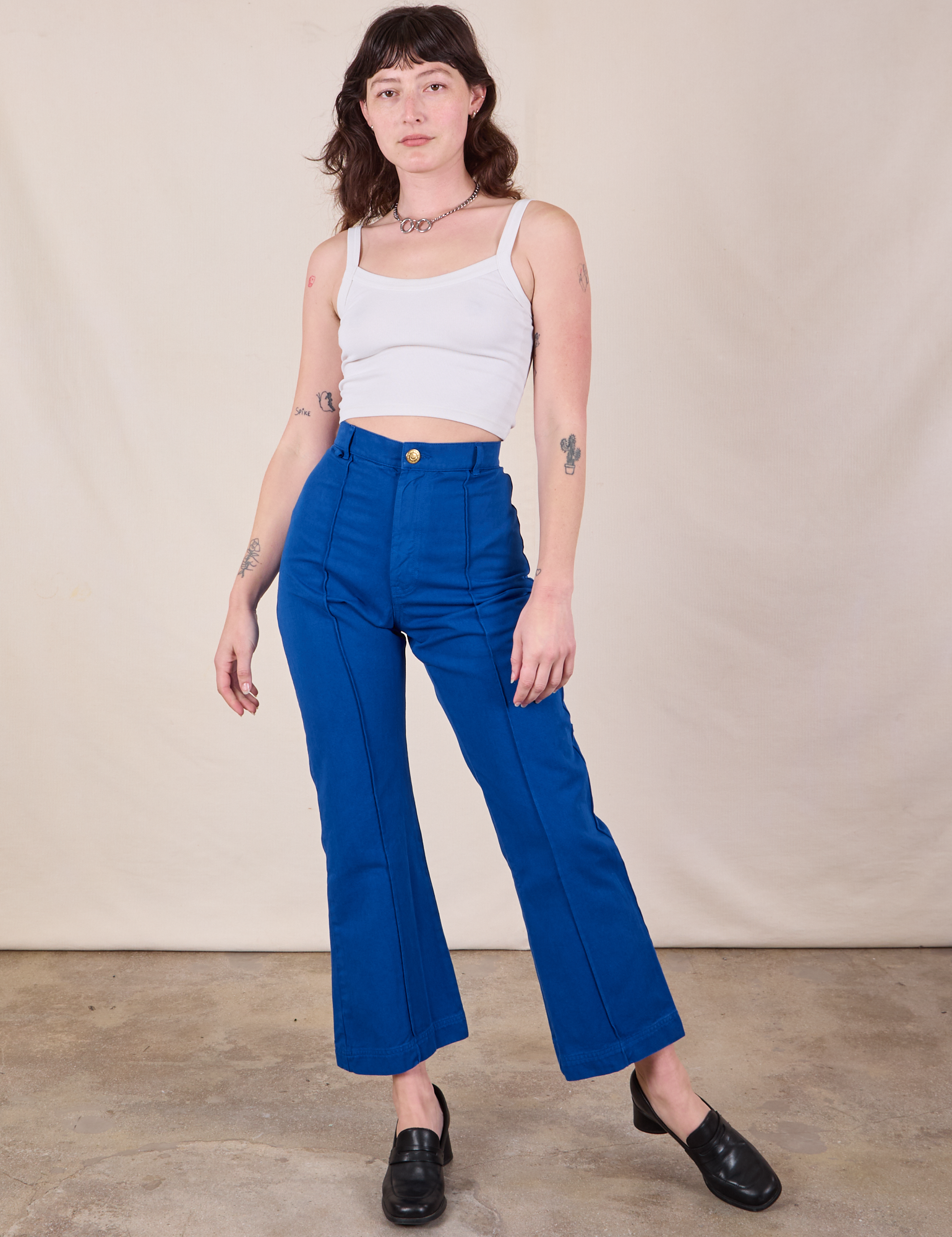 Alex is 5&#39;8&quot; and wearing XS Western Pants in Royal Blue paired with a Cropped Cami in Vintage Tee Off-White