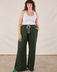 Ryan 5'11" is and wearing 1XL Wide Leg Sweat Pants in Swamp Green and Cropped Tank in vintage tee off-white