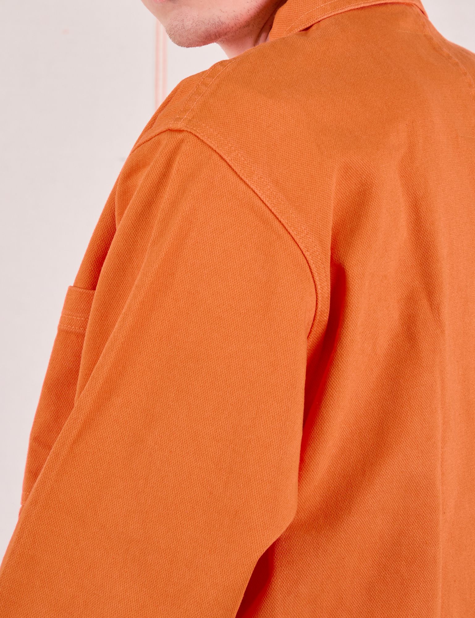 Shoulder close up of Denim Work Jacket in Construction Orange on Quinn