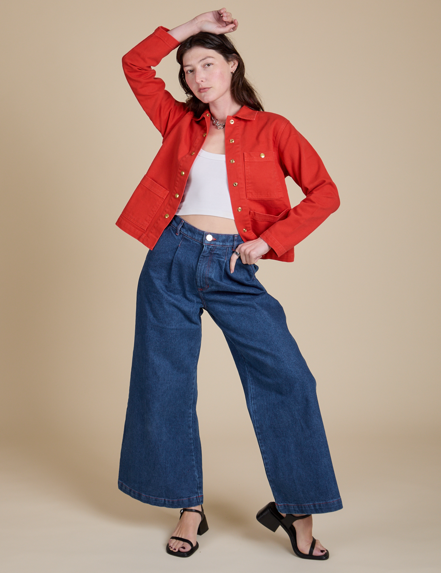 Alex is wearing Denim Work Jacket in Mustang Red paired with dark wash Indigo Wide Leg Trousers