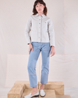 Alex is wearing Denim Work Jacket in Stone White and light wash Carpenter Jeans