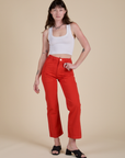 Alex is 5’8” and wearing XS Work Pants in Mustang Red paired with a Cropped Tank in Vintage Tee White