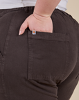 Close up of Ashley's hand in the back pocket of Work Pants in Espresso Brown