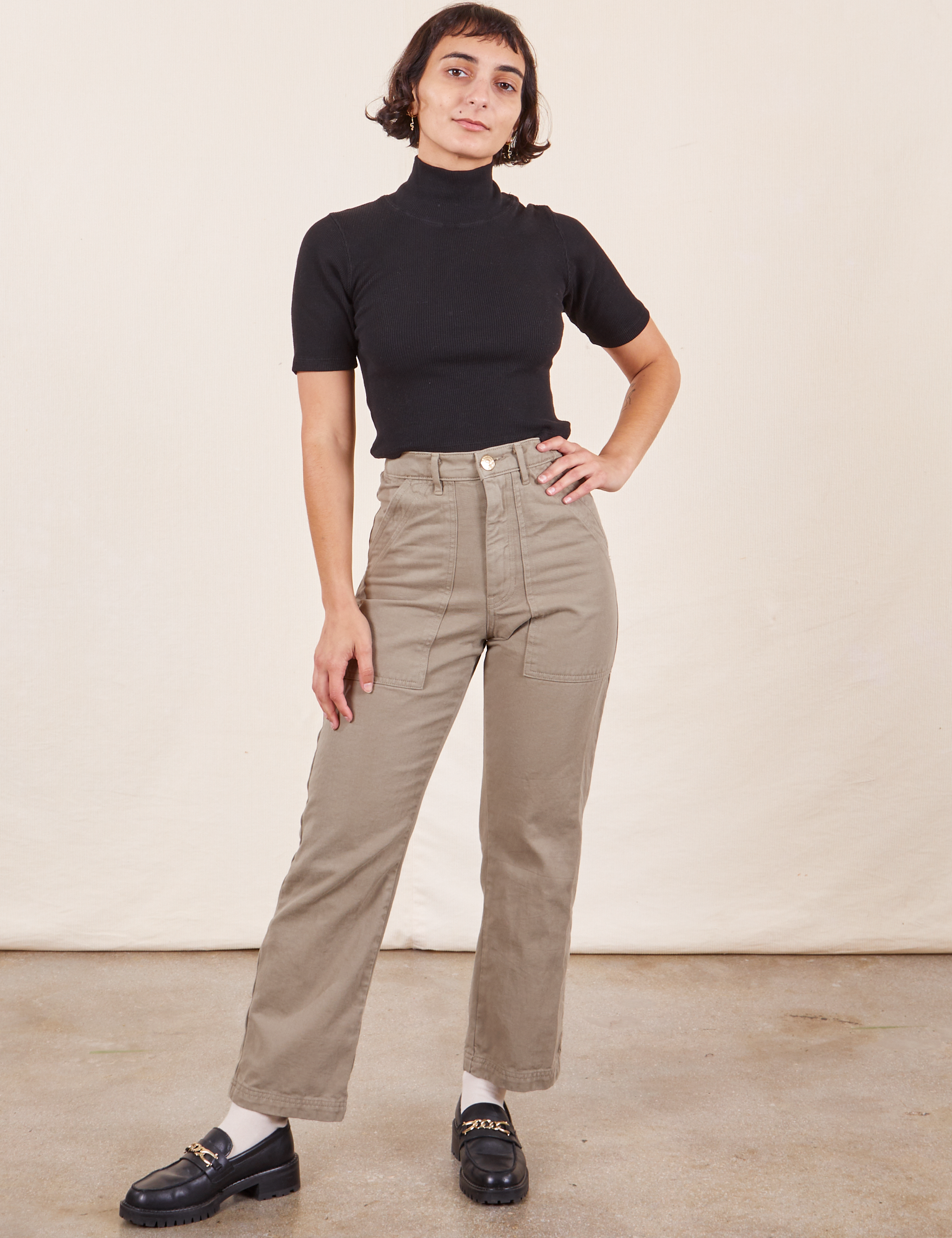 Soraya is 5&#39;2&quot; and wearing Petite XXS Work Pants in Khaki Grey paired with 1/2 Sleeve Turtleneck in black