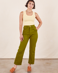 Soraya is 5'2" and wearing Petite XXS Work Pants in Olive Green paired with butter yellow Tank Top