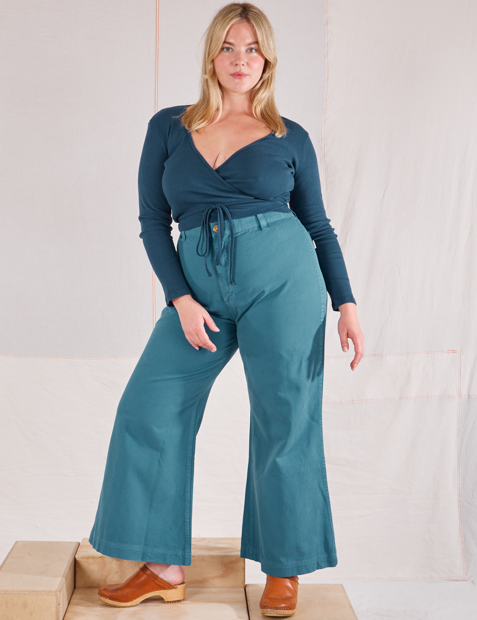 Lish is wearing Wrap Top in Lagoon and marine blue Bell Bottoms