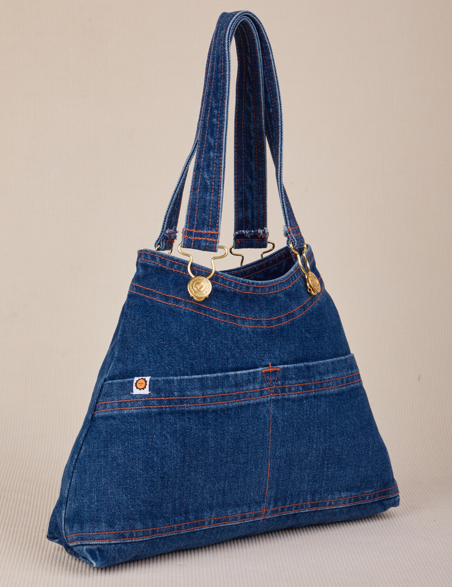 Angled view of dark wash Indigo Overall Handbags