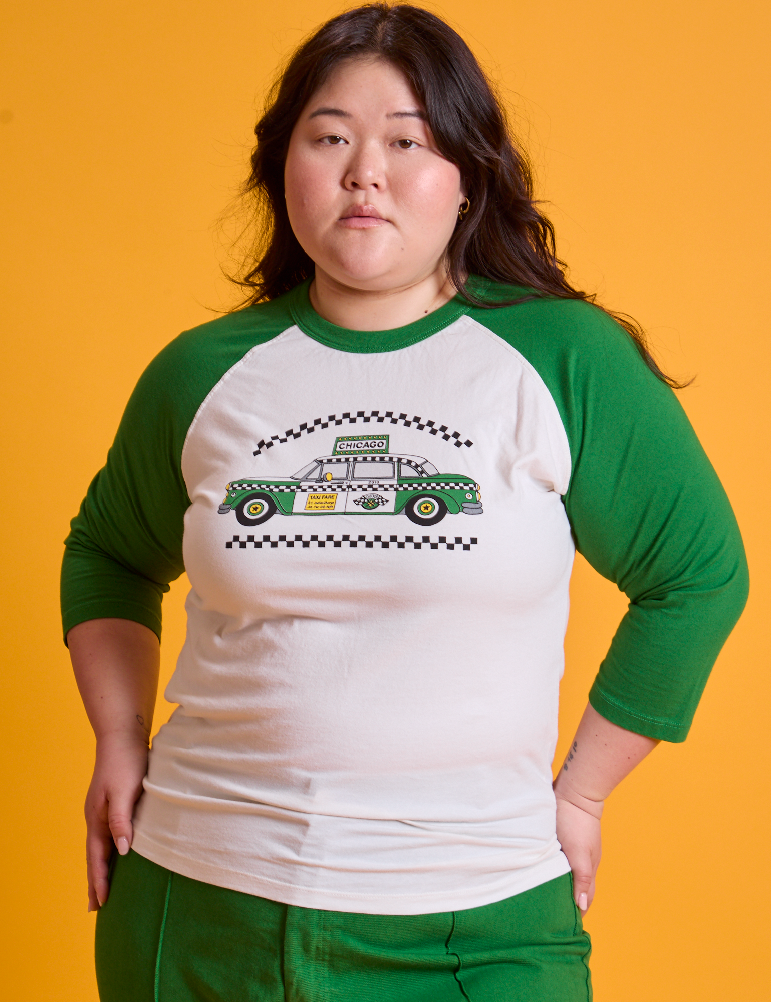 Ashley is 5&#39;7&quot; and wearing L Taxi Raglan Tee in Chicago