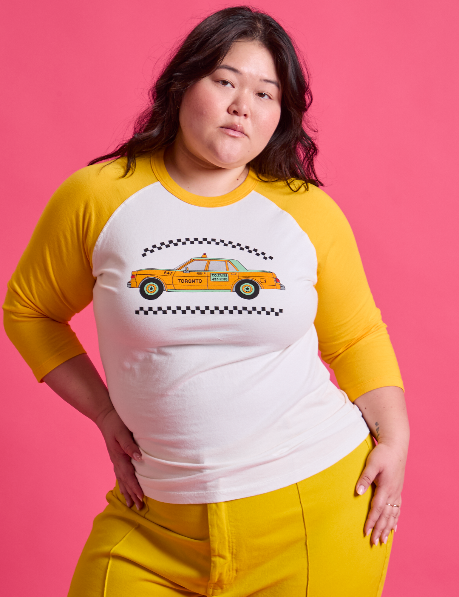 Ashley is 5&#39;7&quot; and wearing L Taxi Raglan Tee in Toronto