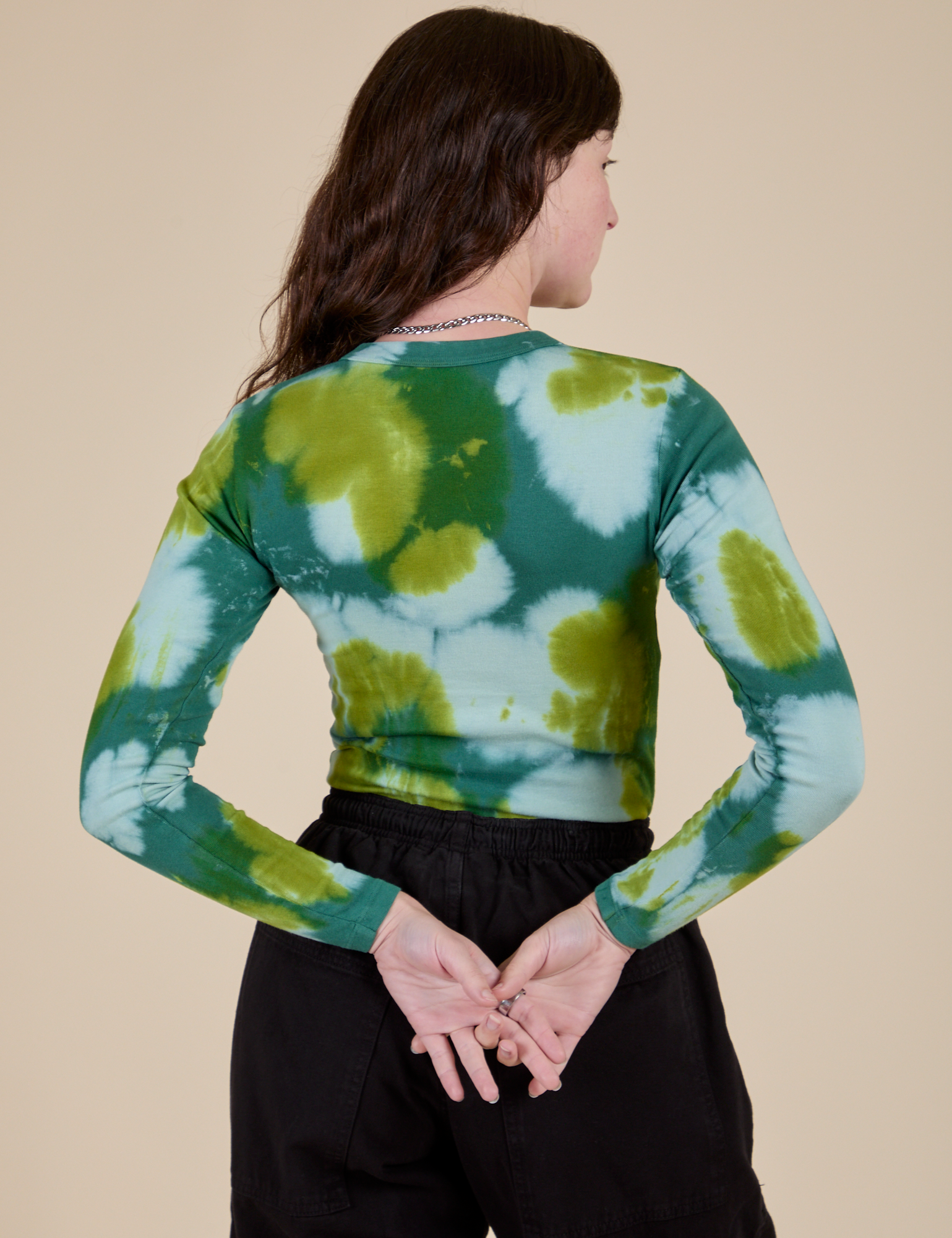 Long Sleeve Baby Tee in Green Magic Waters back view on Alex