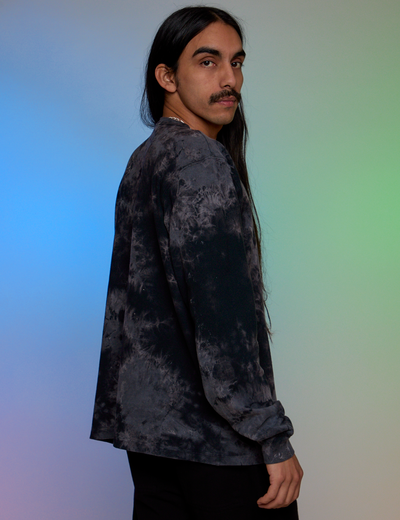 Side view of Magic Waters Long Sleeve Burly Tee in Black on Anthony