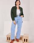 Tiara is wearing Ricky Jacket in Swamp Green with a vintage off-white tee Cami underneath and light wash Carpenter Jeans