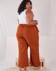 Angled back view of Action Pants in Burnt Terracotta and Cropped Tank in vintage tee off-white worn by Morgan