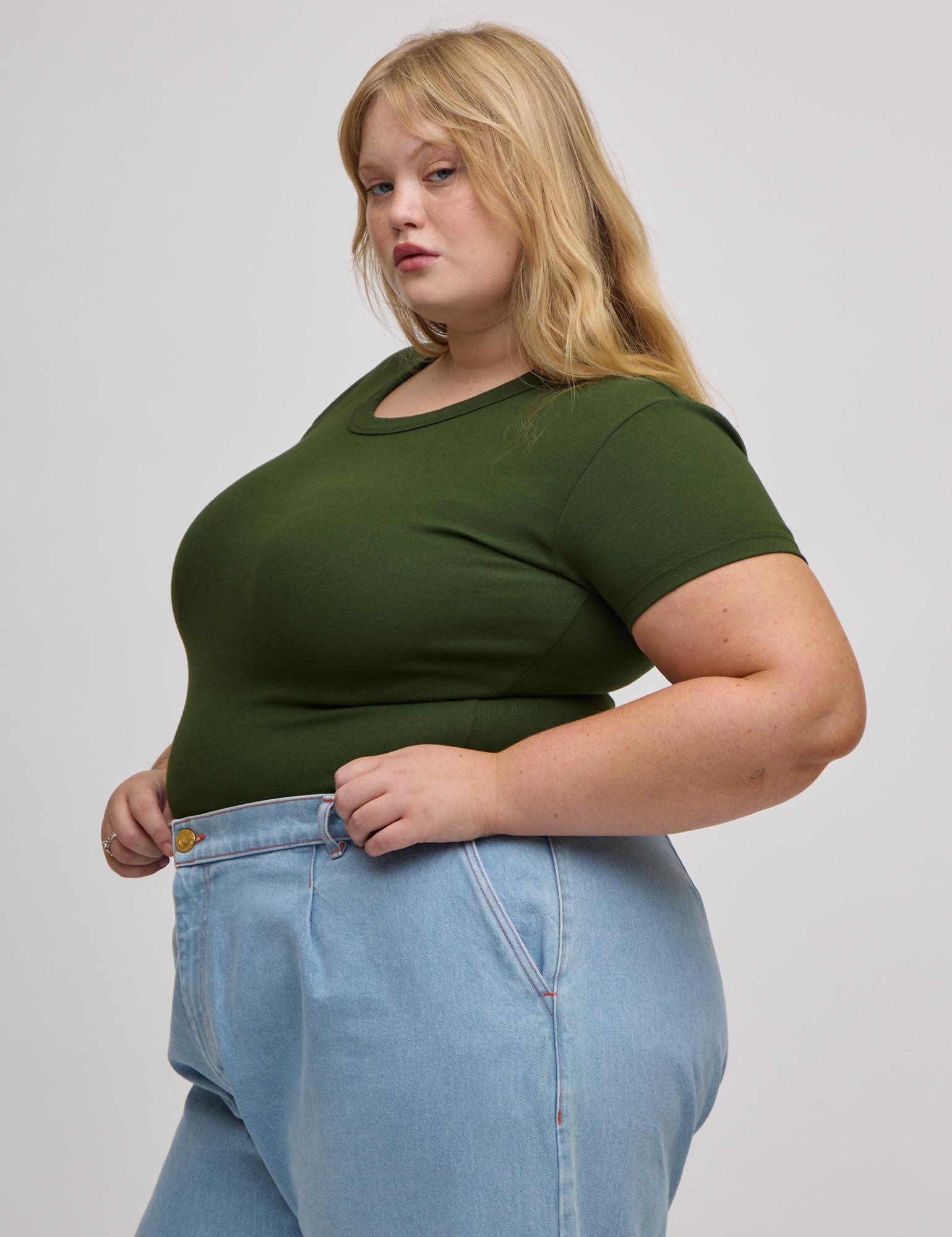 Angled front view of Baby Tee in Evergreen on Juliet