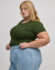 Angled front view of Baby Tee in Evergreen on Juliet