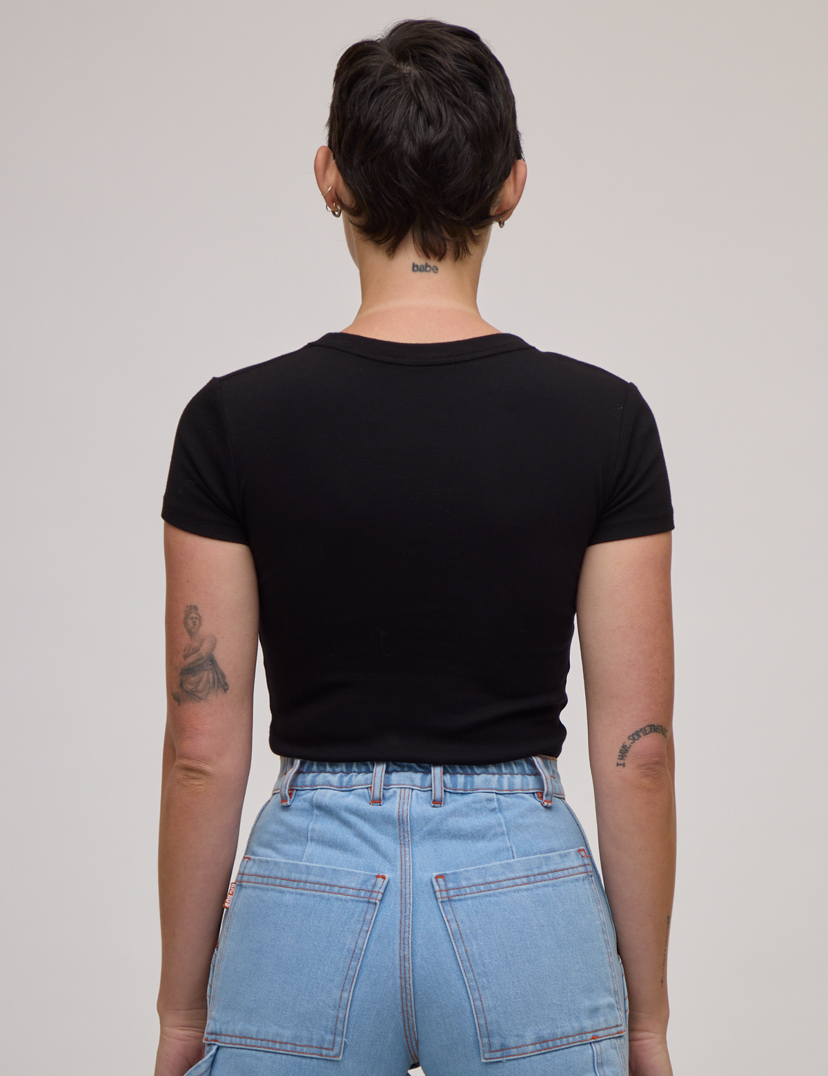 Back view of Baby Tee in Basic Black on Alex