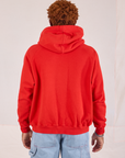 Collegiate Hoodie in Mustang Red back view on Issac