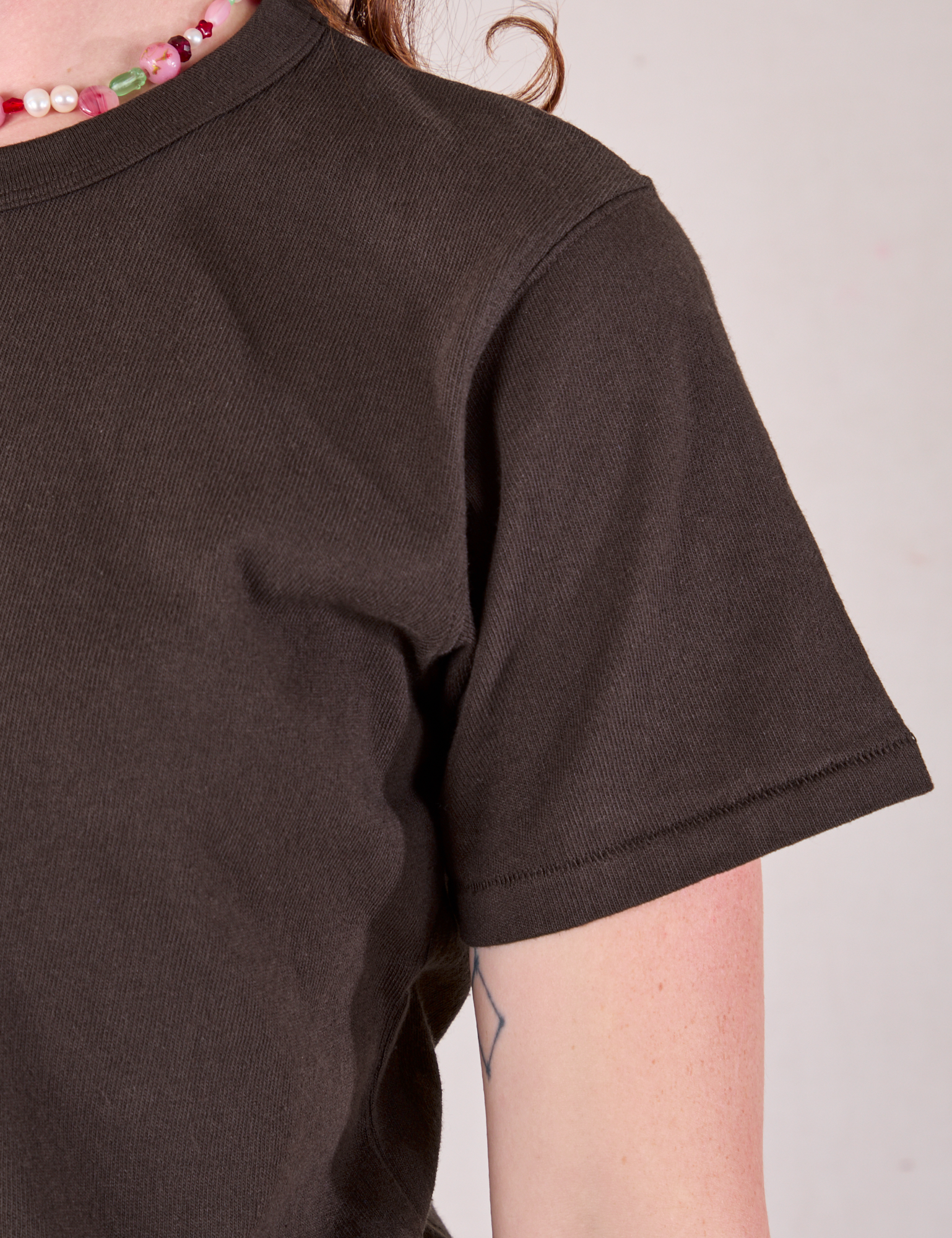 Burly Tee in Espresso Brown sleeve close up on Alex