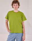 Quinn is 6'3" and wearing S Burly Tee in Gross Green