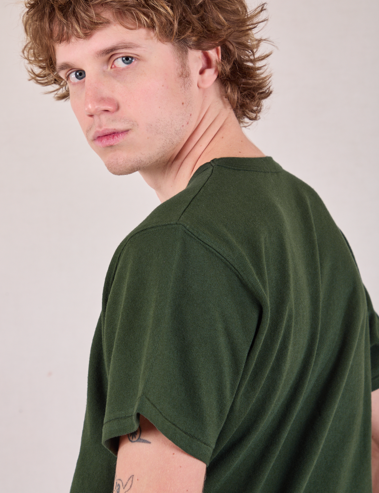 Burly Tee in Swamp Green shoulder close up on Quinn