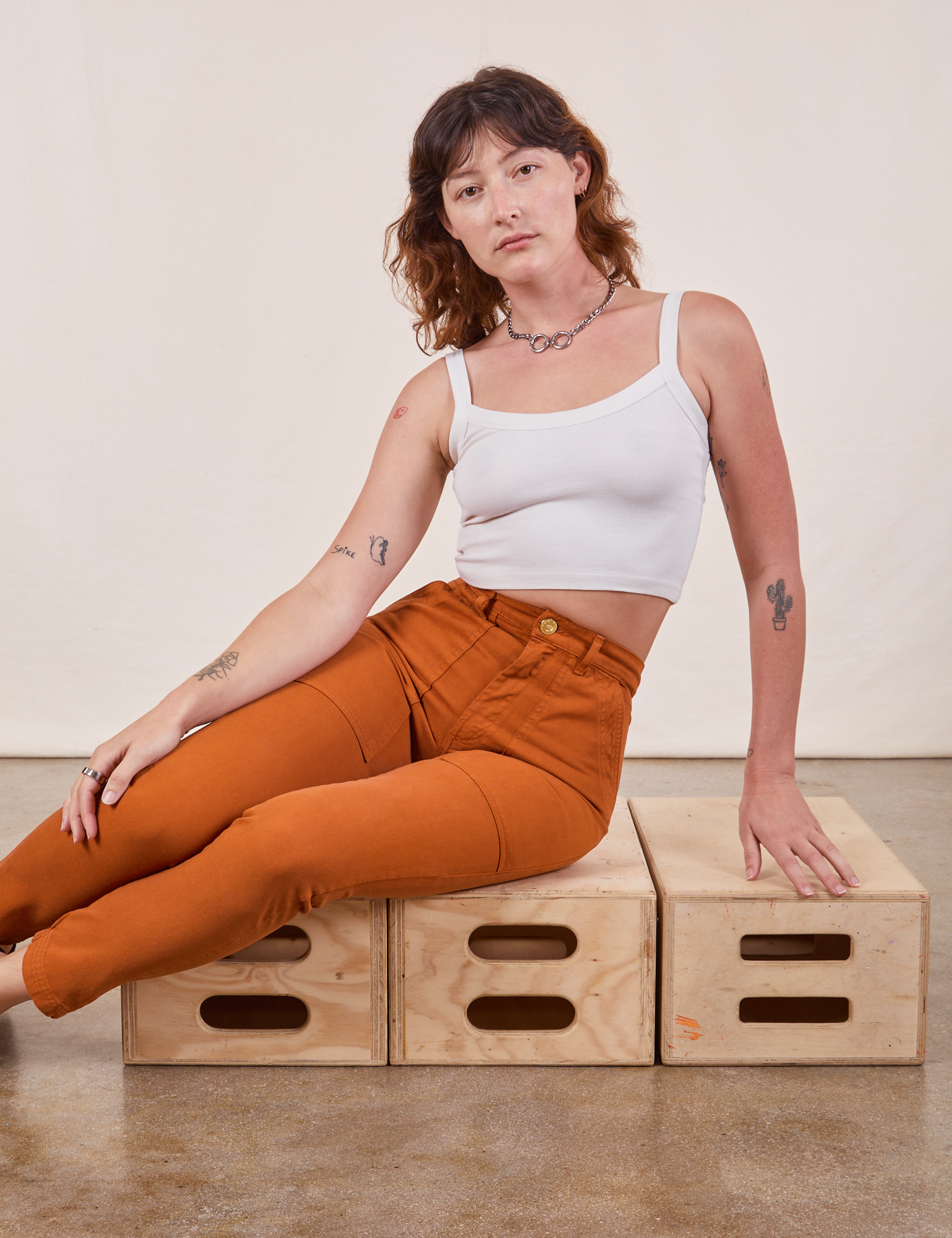 Alex is wearing Pencil Pants in Burnt Terracotta and vintage off-white Cropped Cami