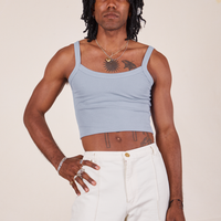 Jerrod is 6'3" and wearing S Cropped Cami in Periwinkle paired with vintage off-white Western pants