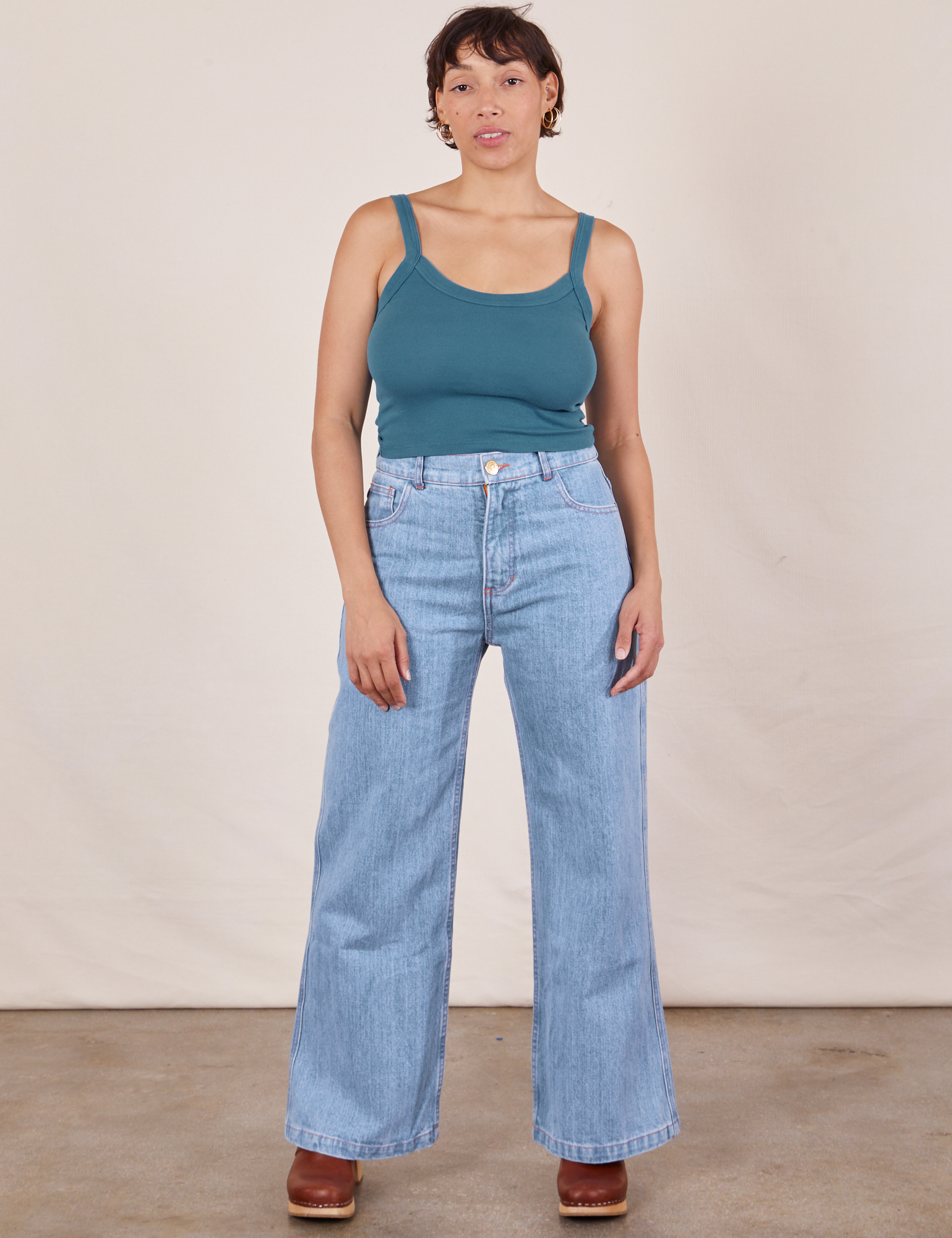 Tiara is wearing Cropped Cami in Marine Blue and light wash Sailor Jeans