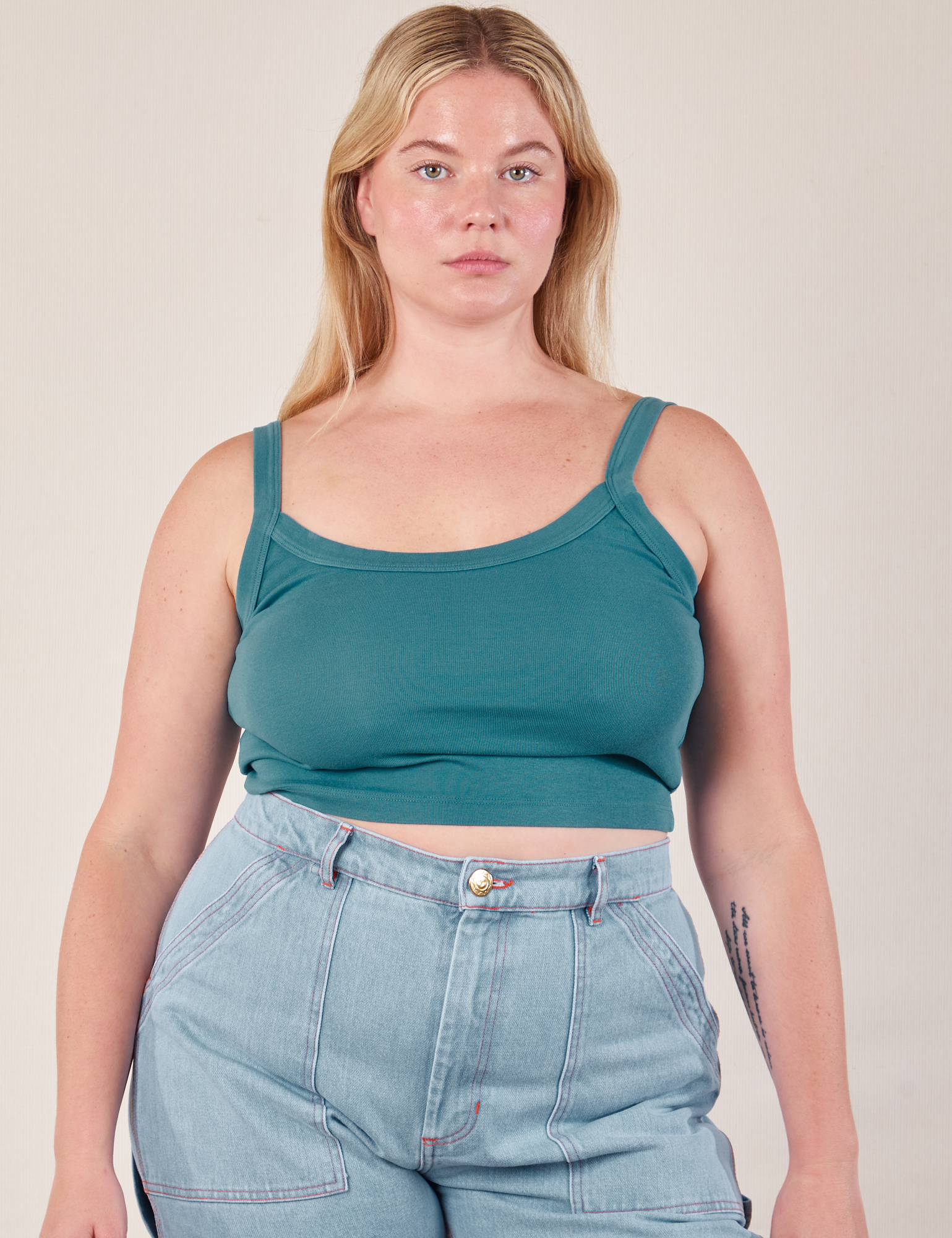 Lish is 5’8” and wearing M Cropped Cami in Marine Blue paired with light wash Carpenter Jeans