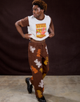 Isaac is wearing Vintage Tee in Gummy Bear and Gummy Bear Paintstamped Work Pants in Fudgesicle Brown