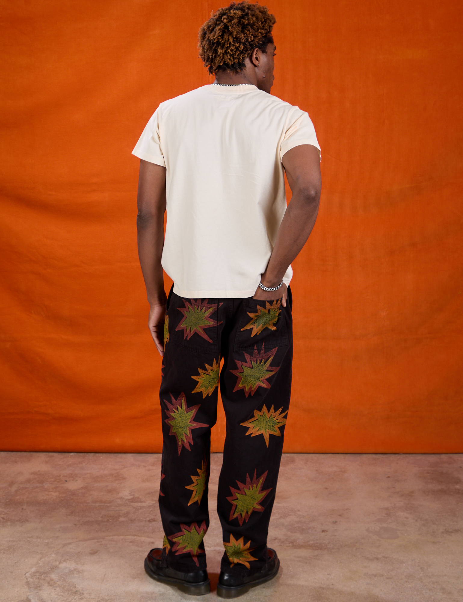 Back view of Paintstamped Work Pants in Explosion and Organic Vintage Tee in Vintage Off-White