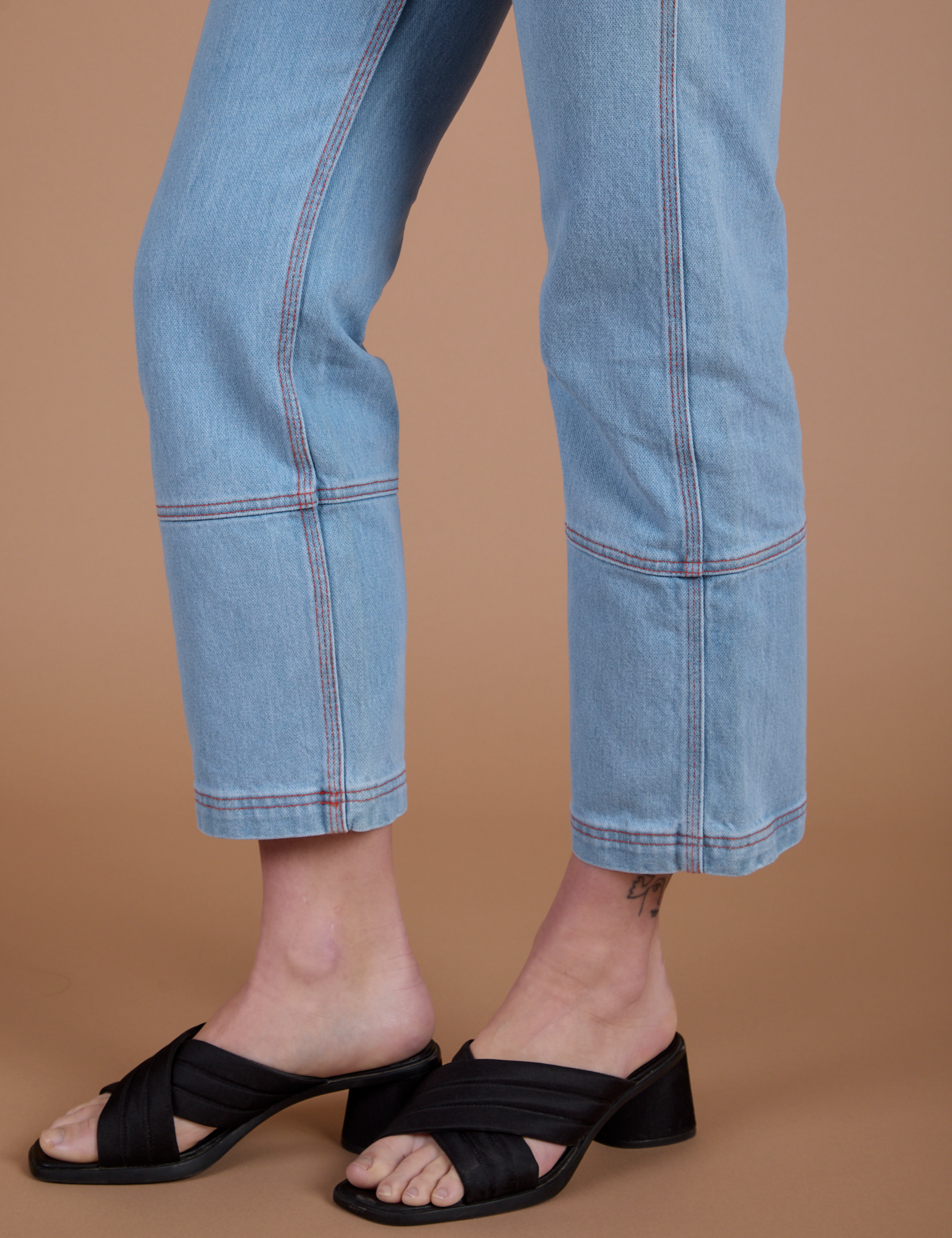 Carpenter Jeans in Light Wash pant leg side view on Alex